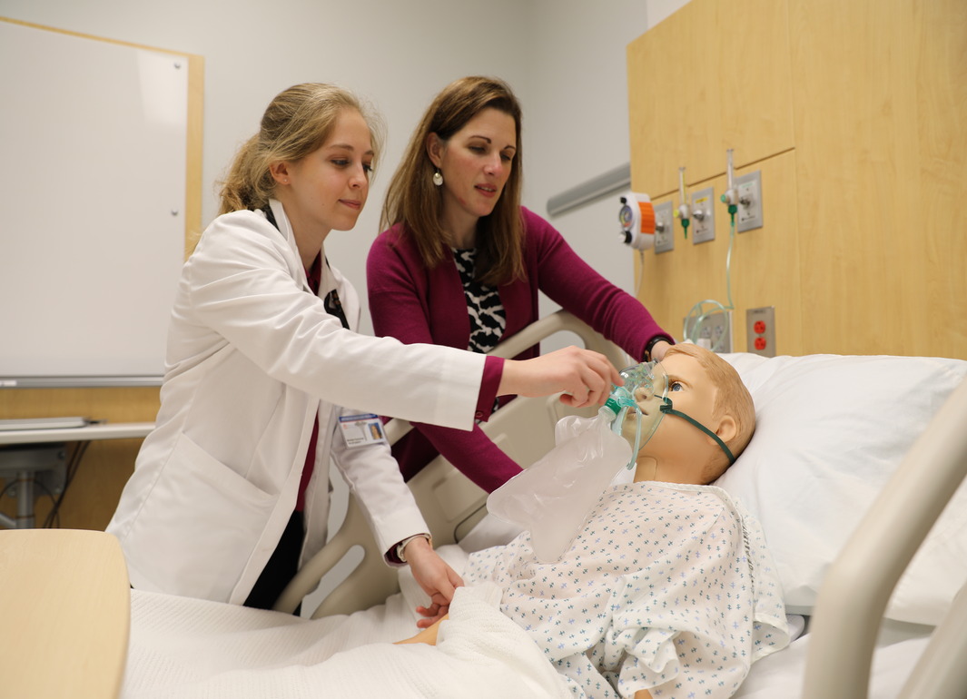 student looking at a patient