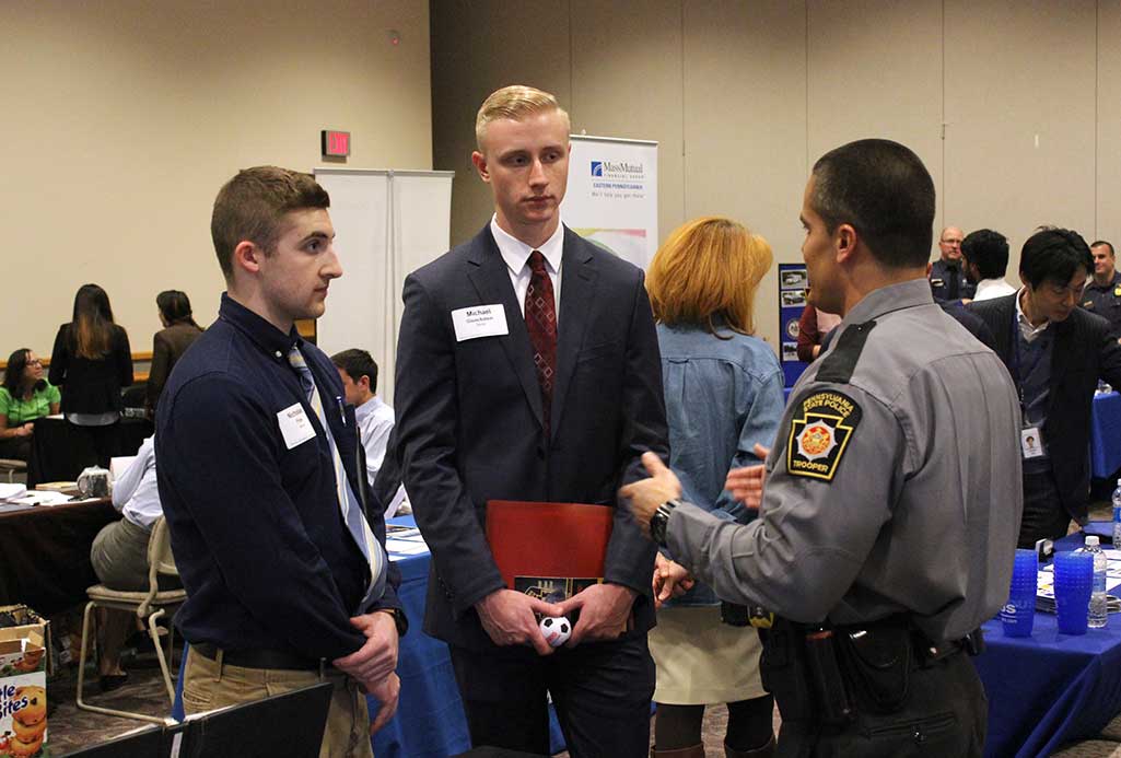 students networking with an alumni