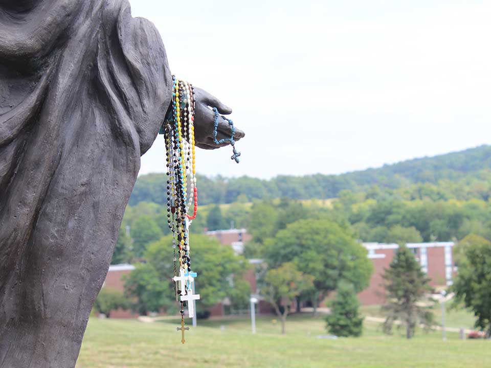 rosary beads on statue