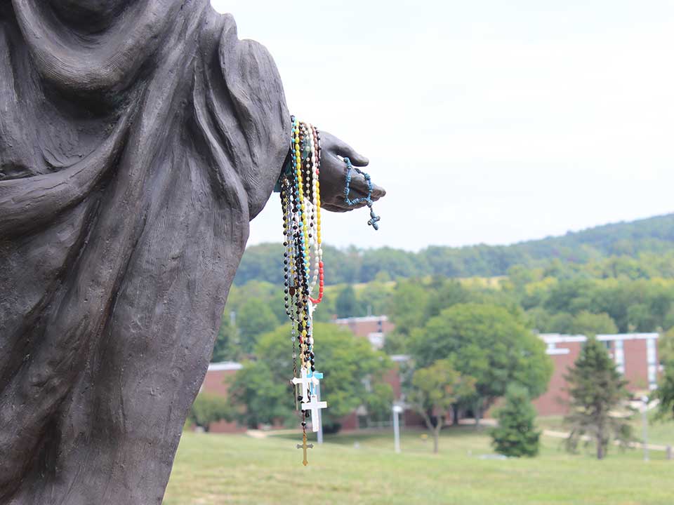 statue with rosary beads