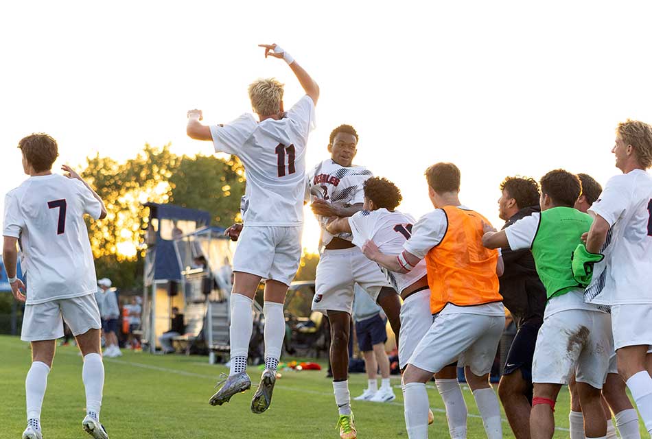 desales mens soccer team celebrating a goal