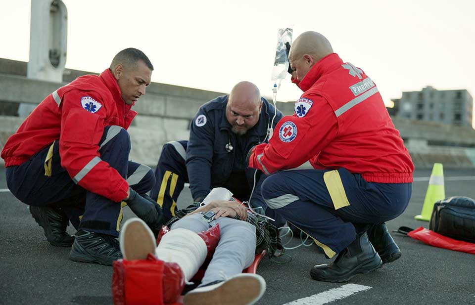 paramedics helping a patient after an accident