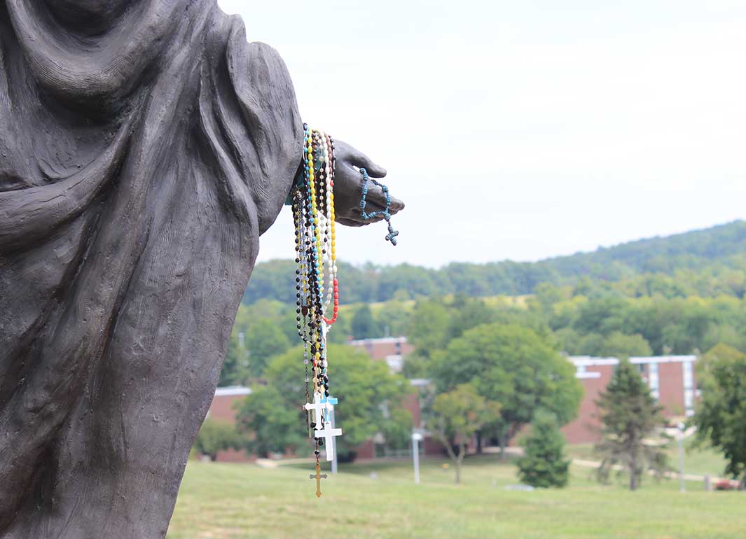 rosary beads on a statue