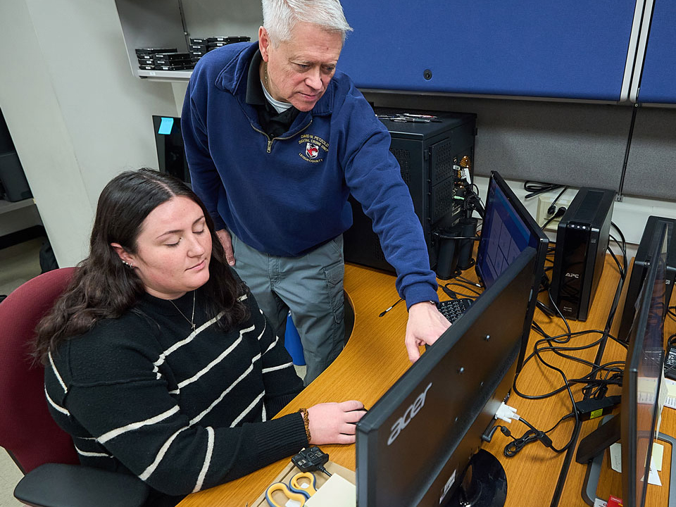 student and professor in computer lab