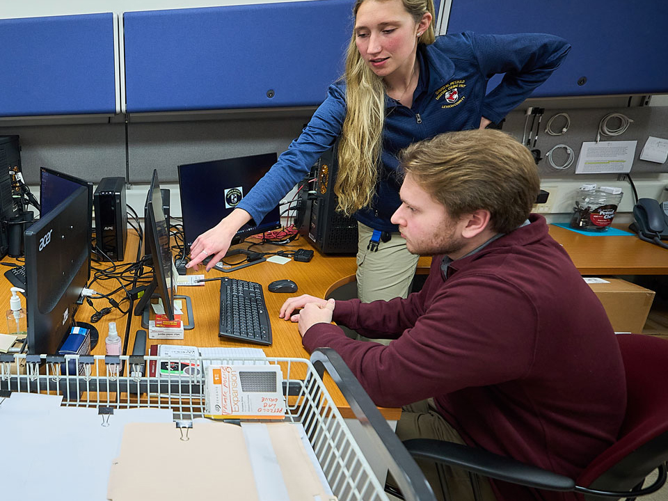 group of people looking at a computer