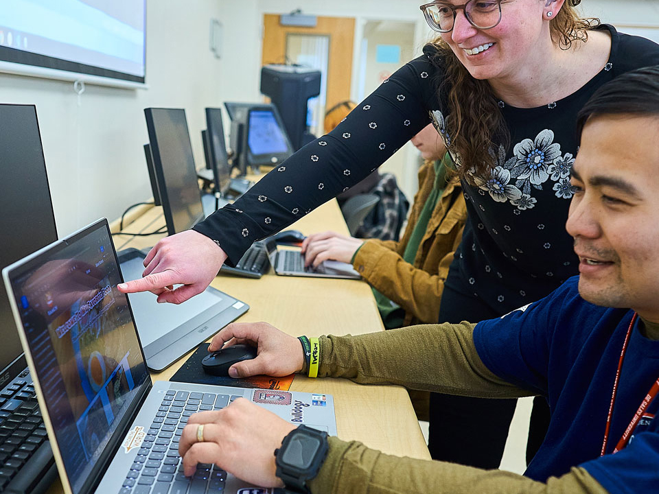 professor helping a student with technology