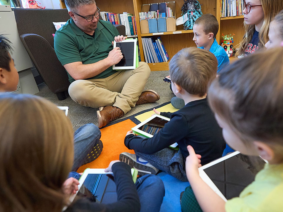 children listening to a teacher