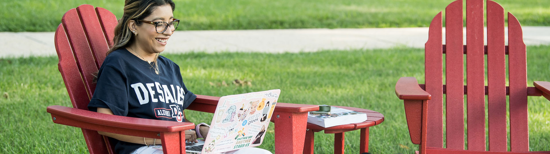 Girl sitting on a chair working on her laptop