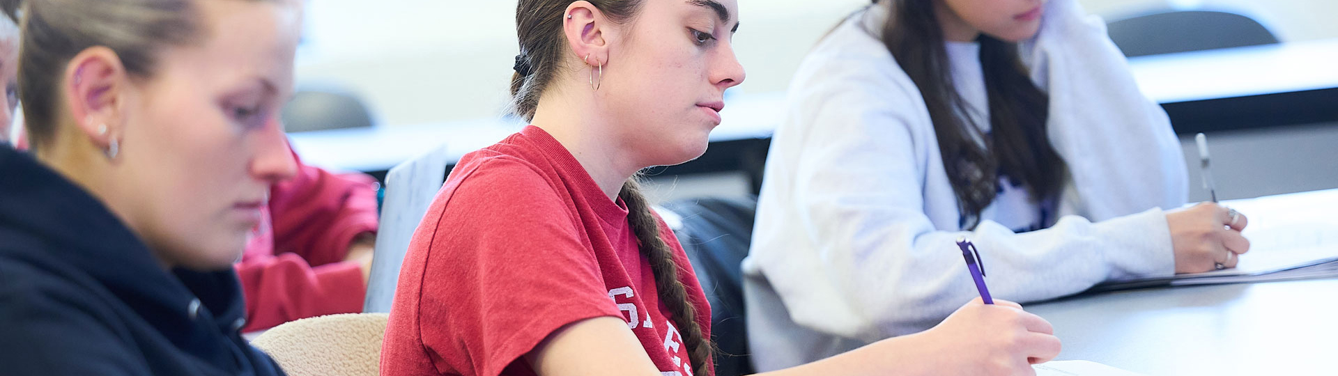 student taking notes in class