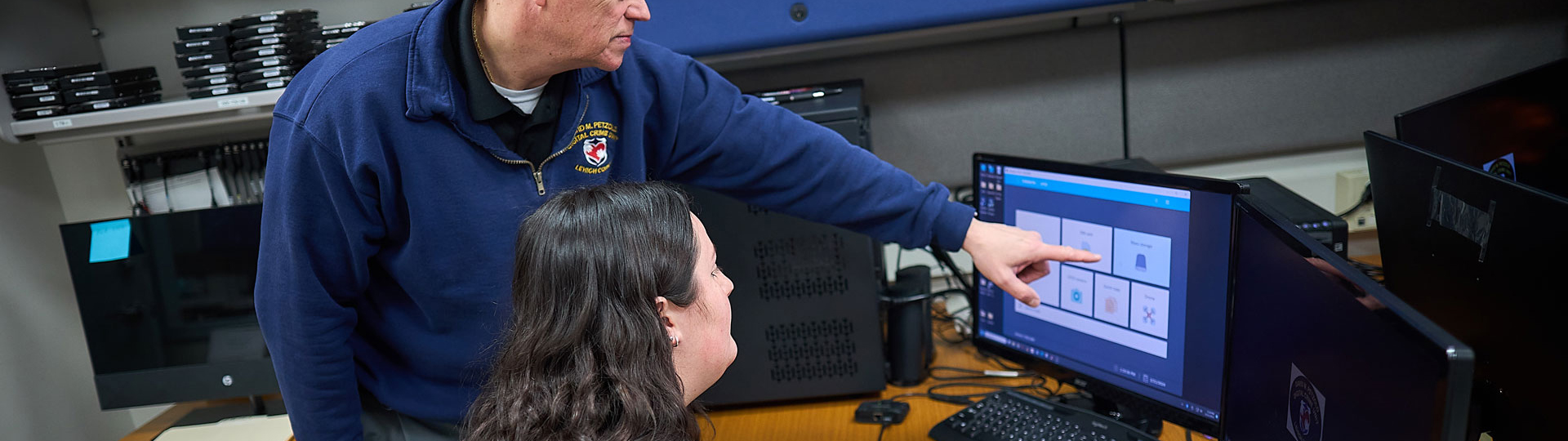 Teacher helping a student using the computer