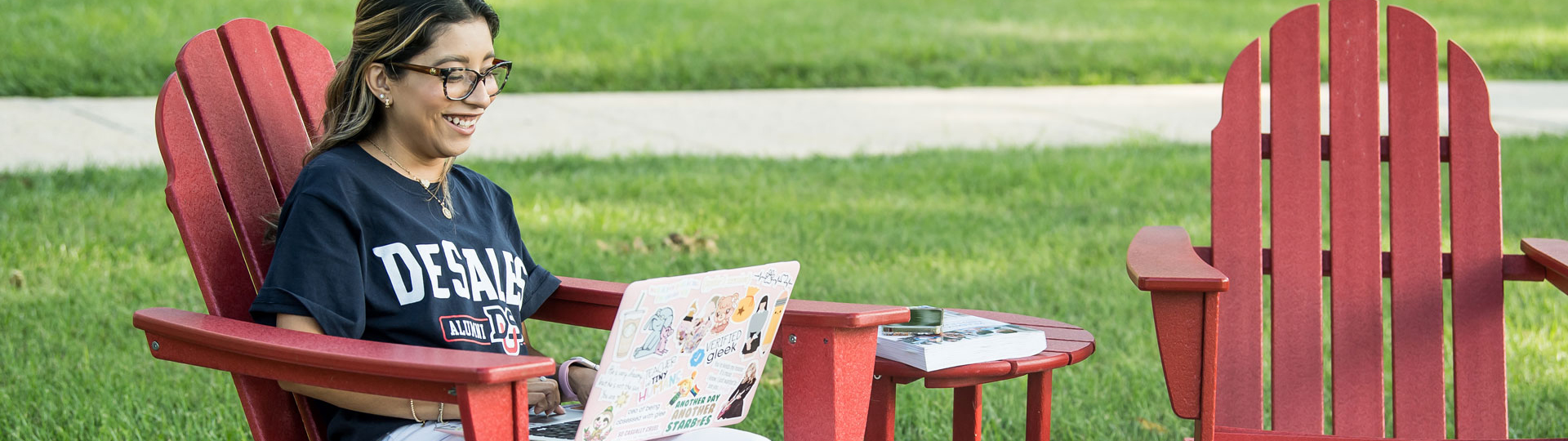 Girl outside working on her laptop