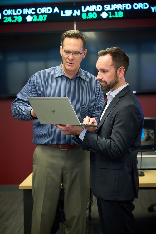 student with professor in classroom