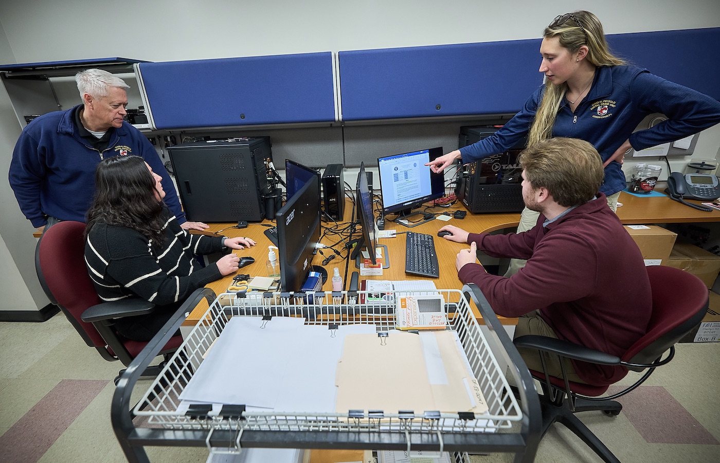 Students and employees of the Petzold Lab look at computer screens