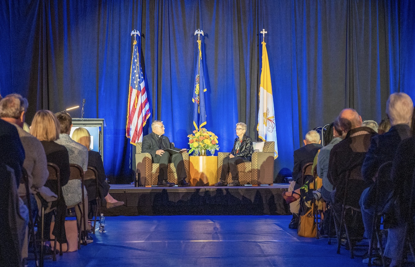 Terry Gross and Father Kevin Nadolski on stage at Marcon Lecture