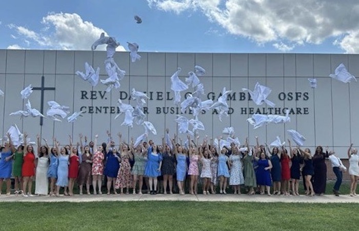 PA students throwing white coats in the air outside the Gambet Center