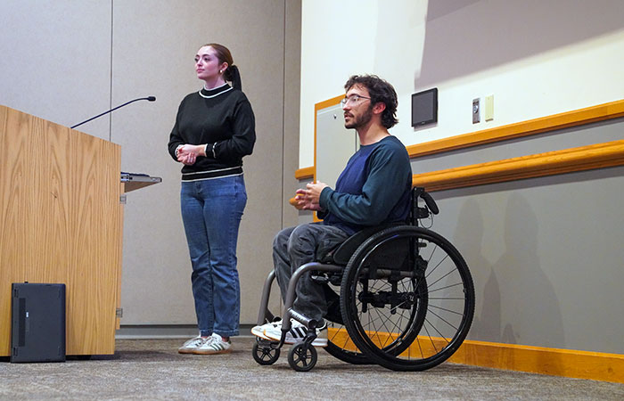adam perone and janae topor giving a presentation