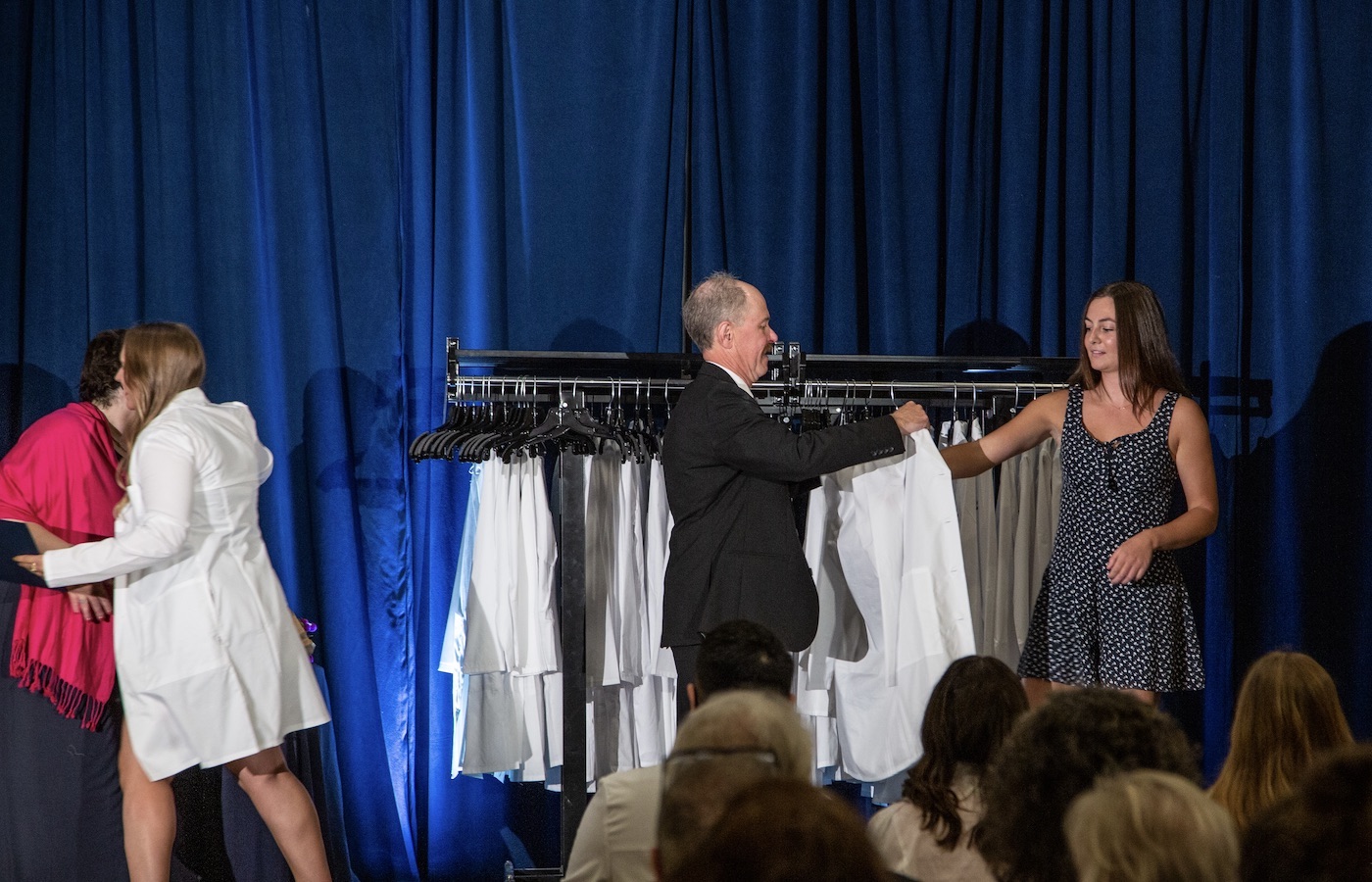 Students receiving their white coats