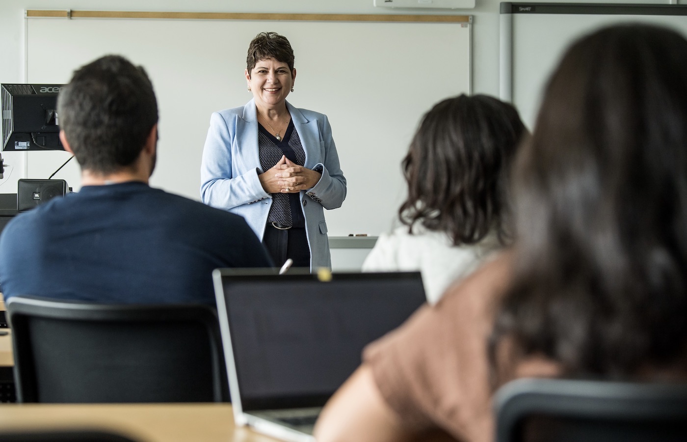 professor standing at the front of a classroom